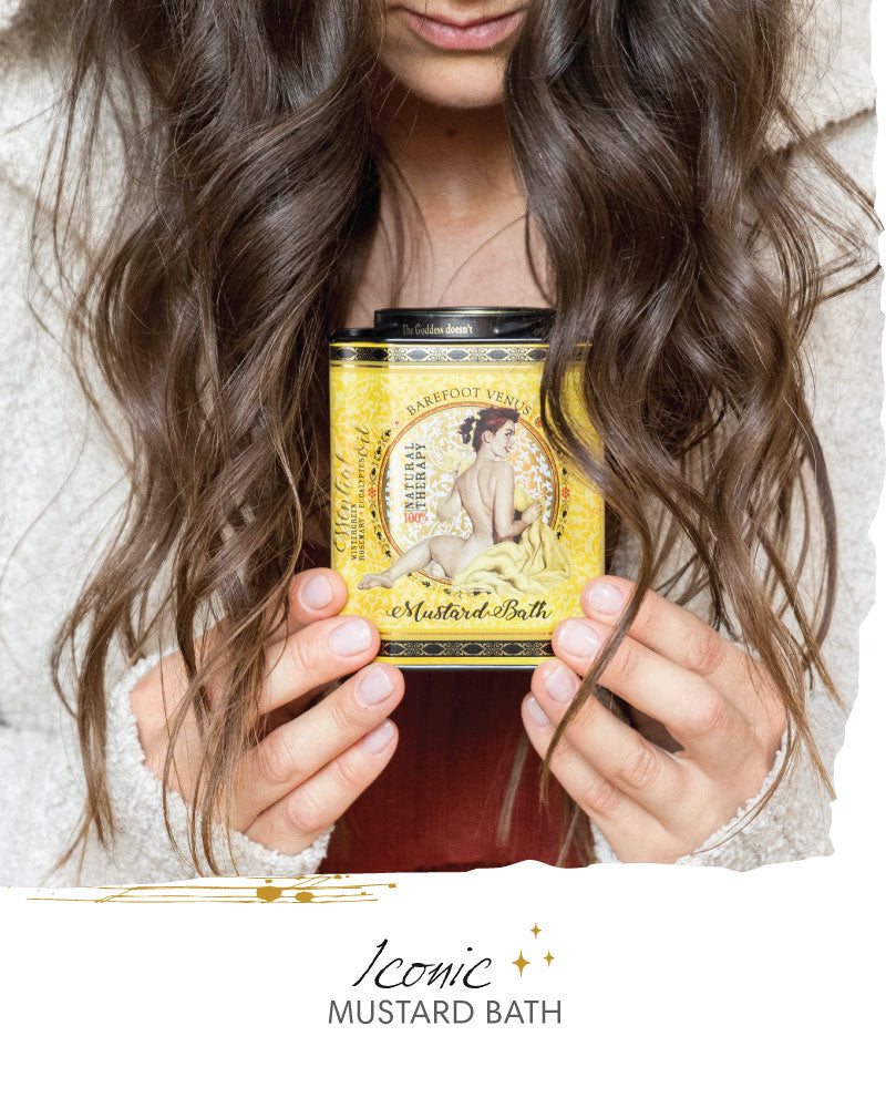 Person holding a mustard bath tin with long hair, featuring the collection 'Iconic Mustard Bath'.