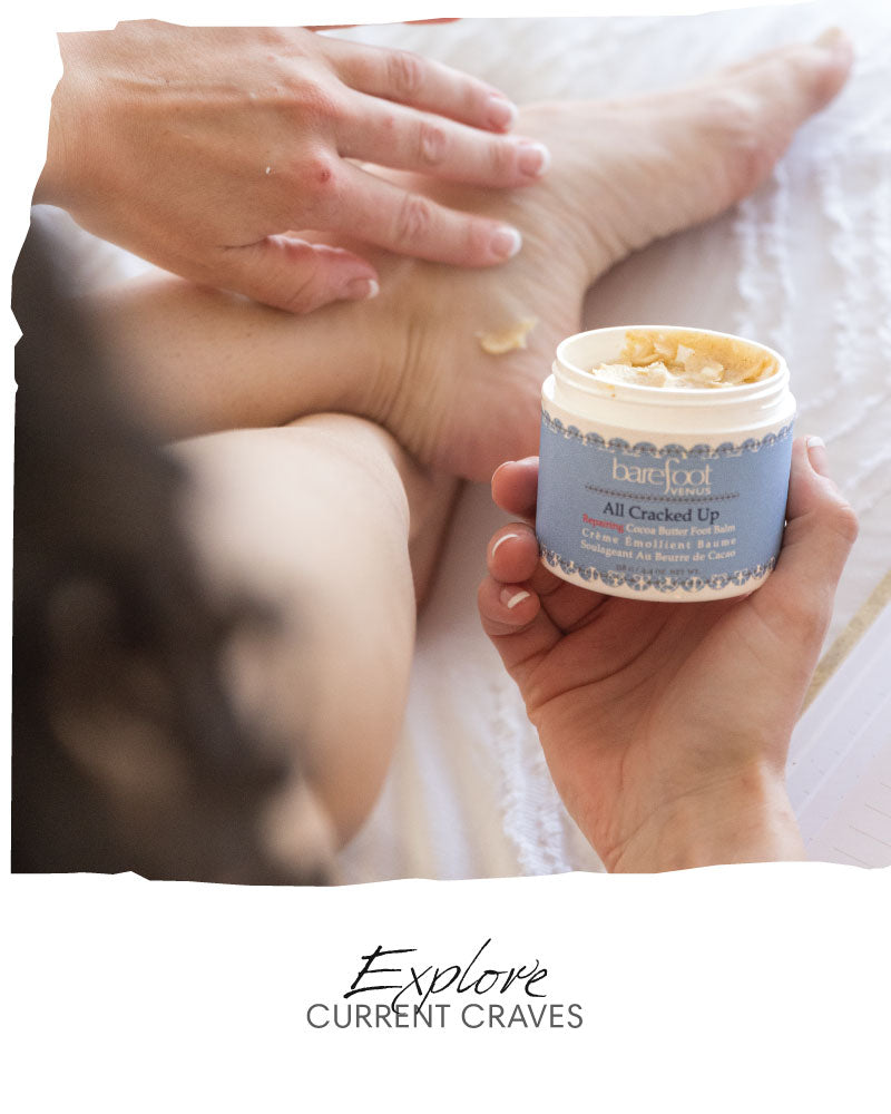 Person applying Barefoot Venus all cracked up to foot with container in hand. Text reads 'Explore - current craves'.